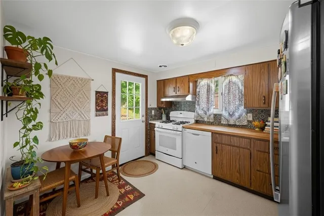 a kitchen with a table chairs and a sink