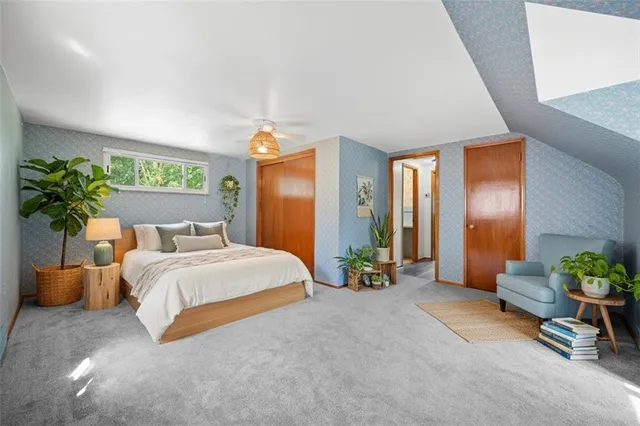 a spacious bedroom with a bed and a couch