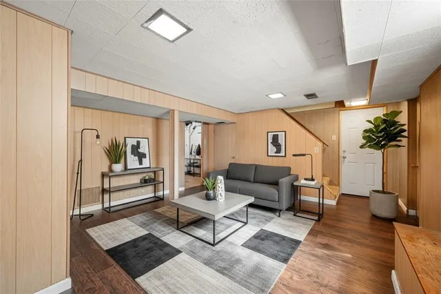 a living room with furniture and a potted plant