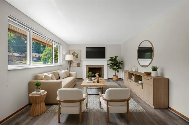 a living room with furniture a window and a fireplace