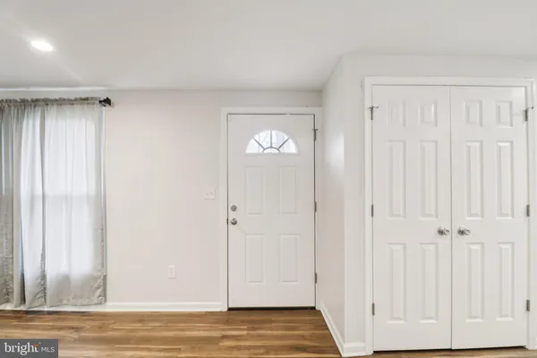 a view of an entryway with wooden floor