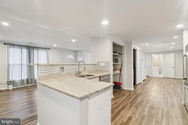 an open kitchen with a sink and refrigerator