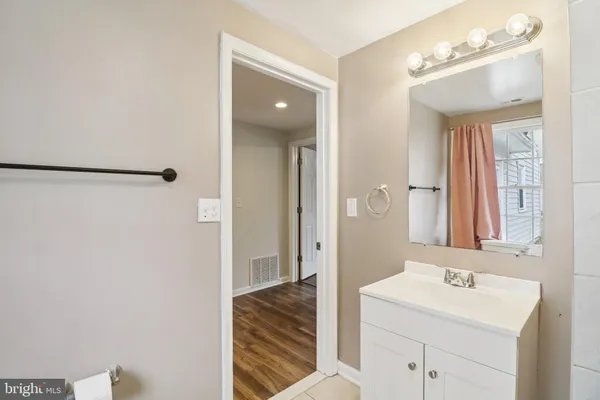 a bathroom with a sink a mirror and a shower