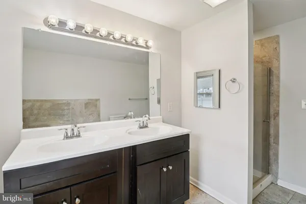 a bathroom with a sink double vanity and a mirror