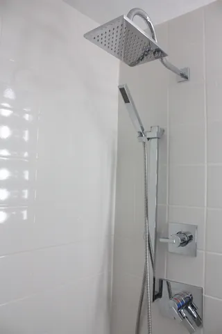 a bathroom with a bathtub and shower