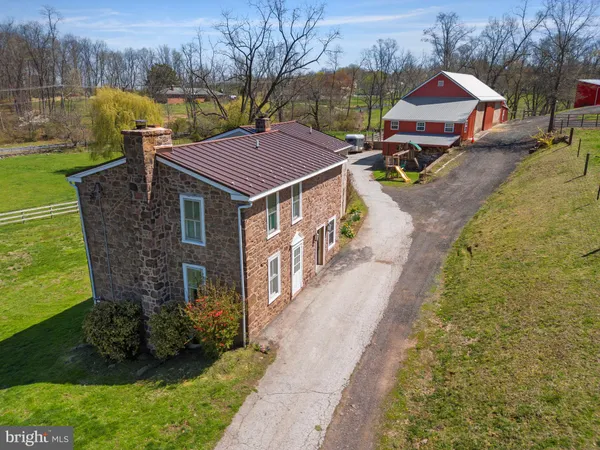 a aerial view of a house with a yard table and chairs
