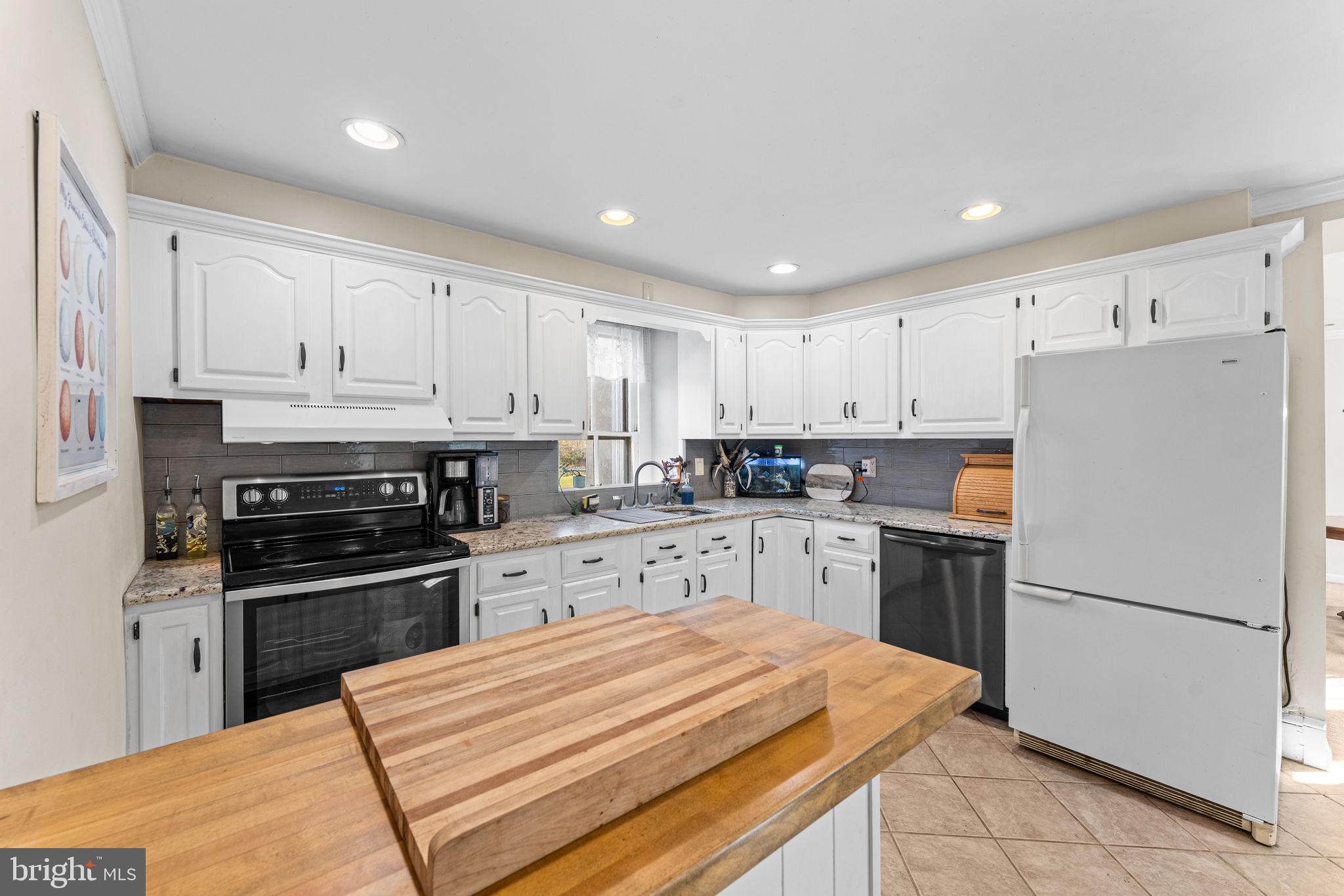120 Alackness Road Spring City, PA 19475 - Photo 19 of 53 a kitchen with white cabinets and stainless steel appliances
