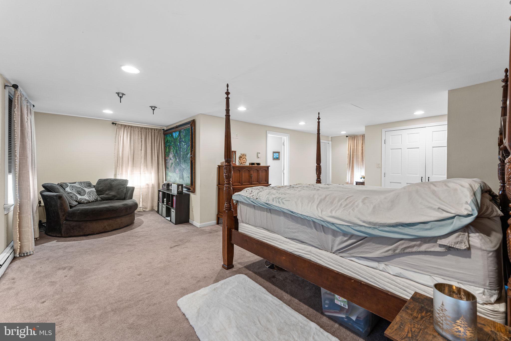 120 Alackness Road Spring City, PA 19475 - Photo 31 of 53 a spacious bedroom with a bed a couch and a dresser