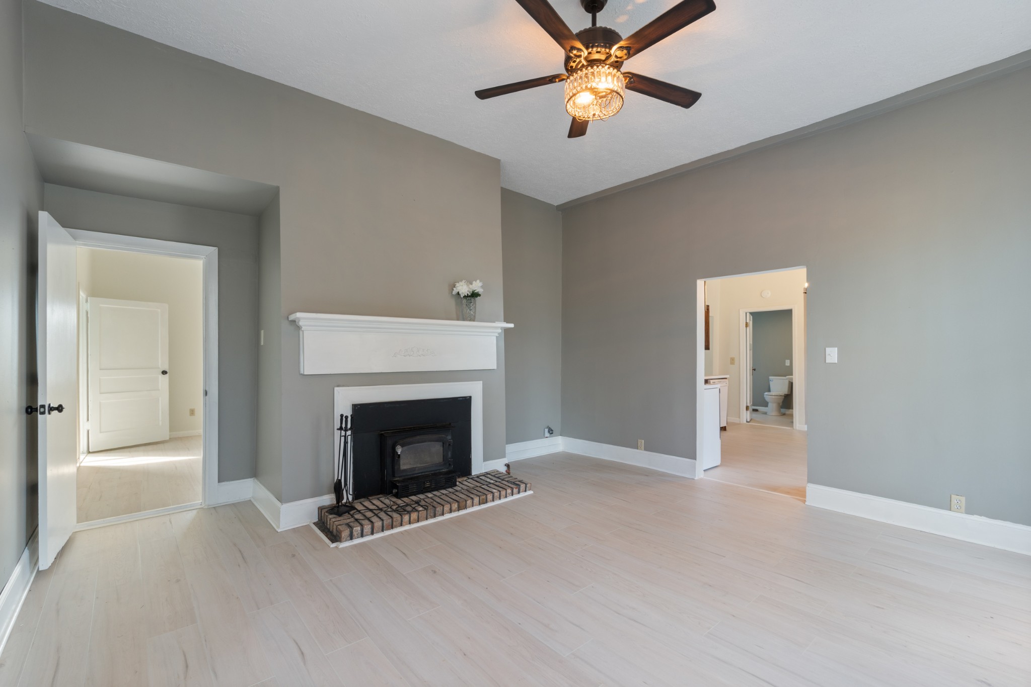 126 West End Avenue Centerville, TN 37033 - Photo 13 of 37 a view of an empty room with chandelier fan and fire place