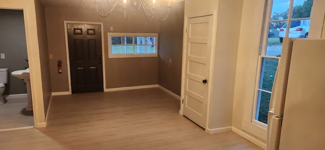 an entryway at an empty room with a door