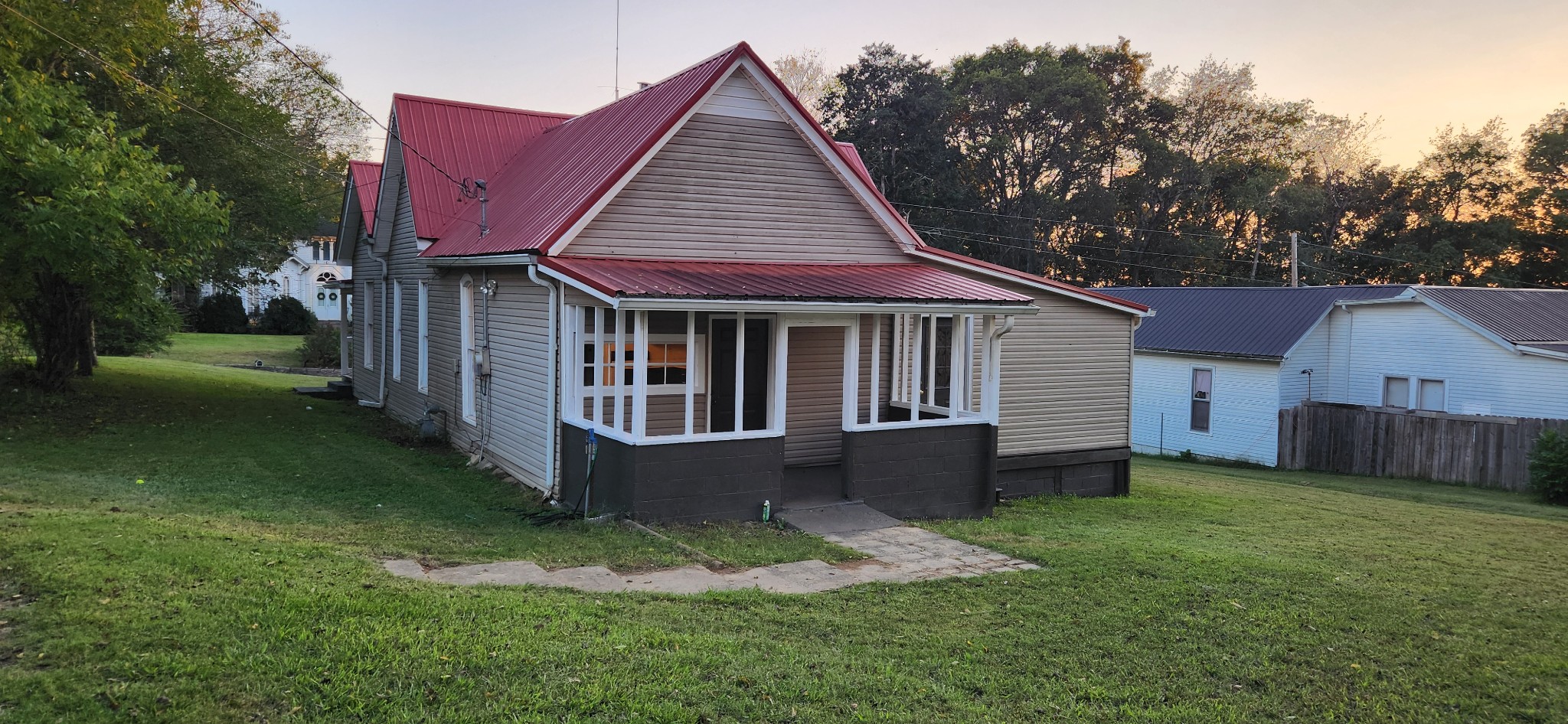 126 West End Avenue Centerville, TN 37033 - Photo 5 of 28 a view of a house with a yard plants and large tree