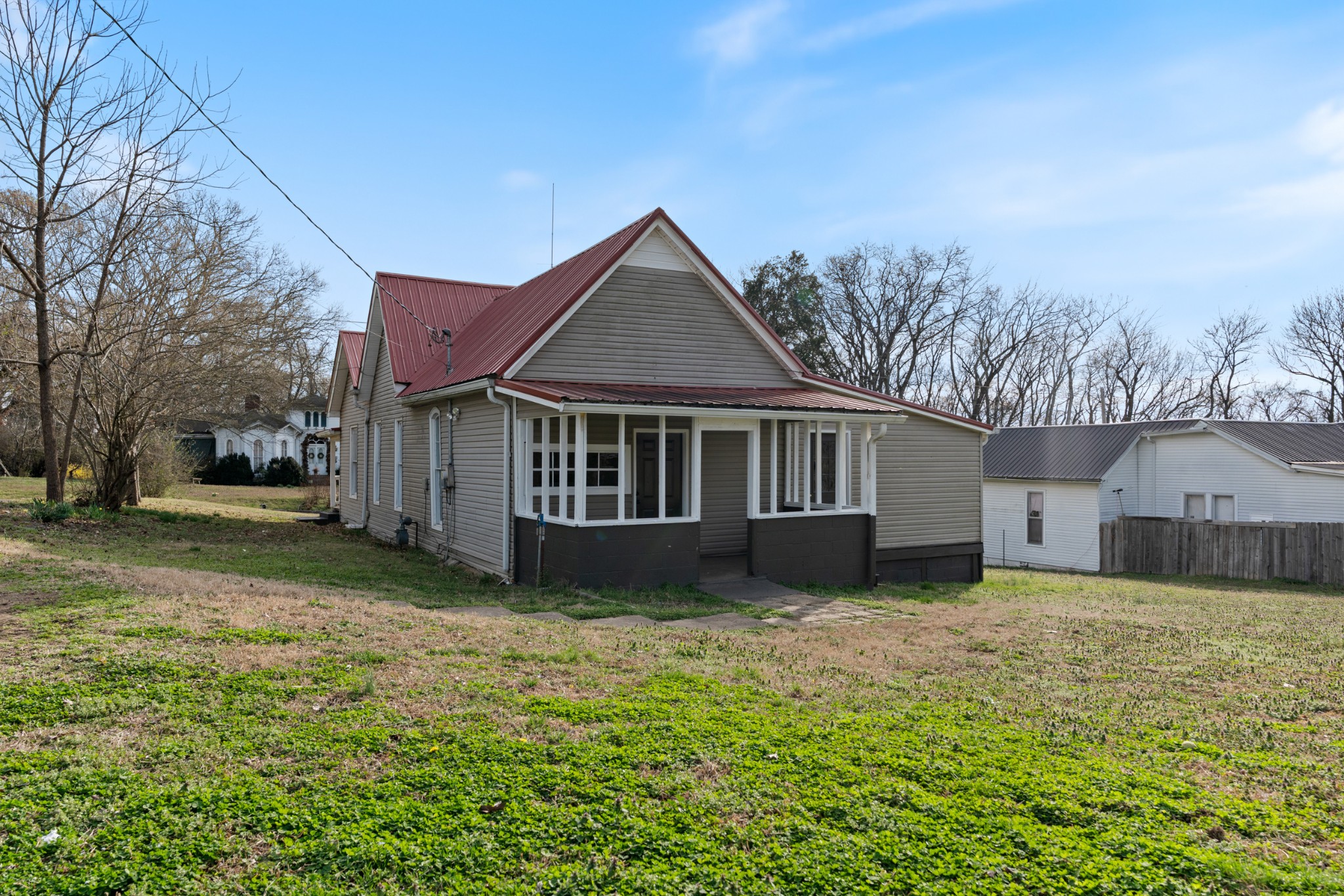 126 West End Avenue Centerville, TN 37033 - Photo 8 of 37 a house that is sitting in the grass with large trees