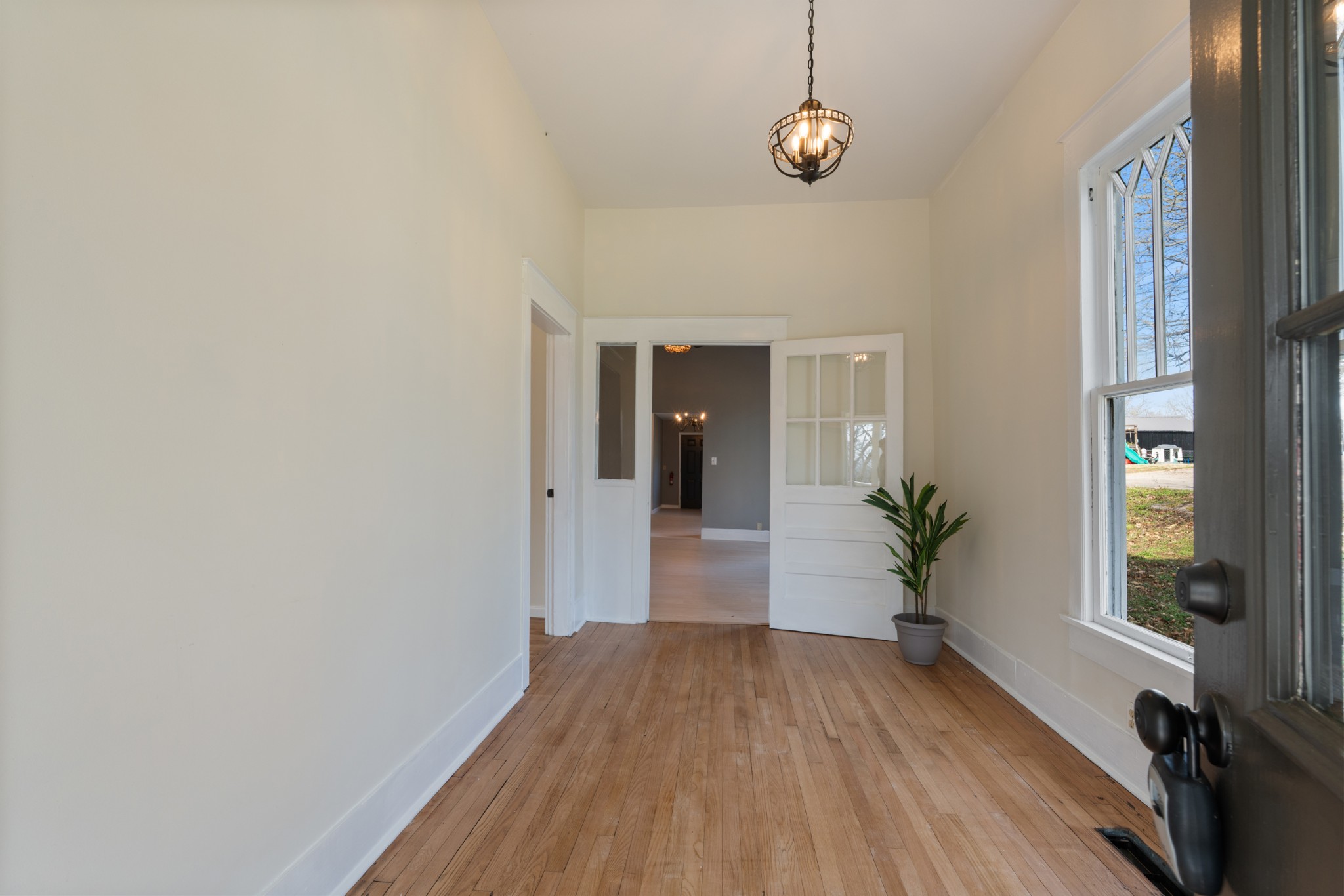 126 West End Avenue Centerville, TN 37033 - Photo 10 of 37 a view of a hallway with wooden floor and a chandelier