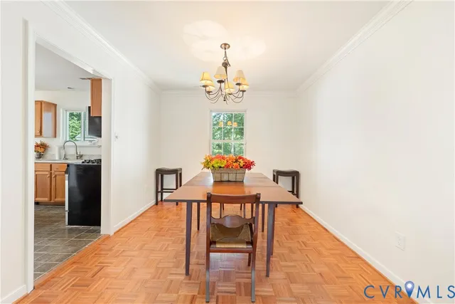 a dining room with furniture and chandelier
