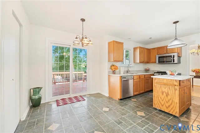 a large kitchen with stainless steel appliances granite countertop a sink and cabinets
