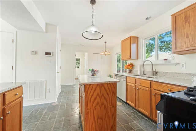 a kitchen with stainless steel appliances granite countertop a stove a sink and a refrigerator