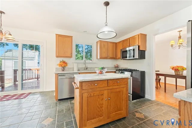a kitchen with kitchen island a sink cabinets and wooden floor