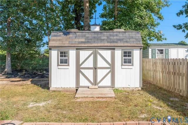 an aerial view of residential houses with outdoor space and swimming pool