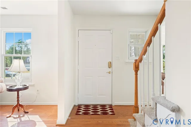 a view of entryway and hall with wooden floor