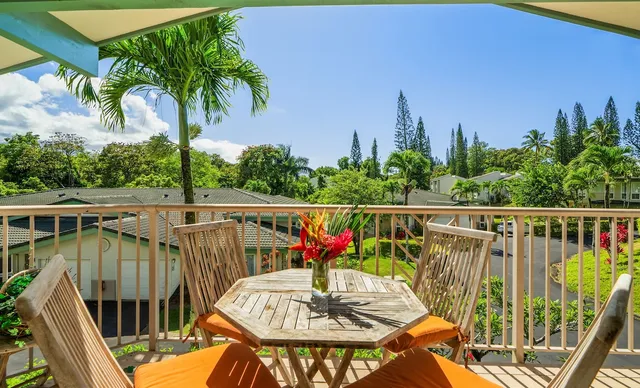 a view of a balcony with chairs and wooden floor
