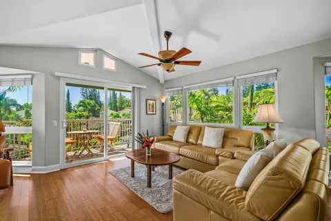 a living room with furniture and a large window with outer view