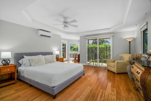 a bedroom with a large bed and windows