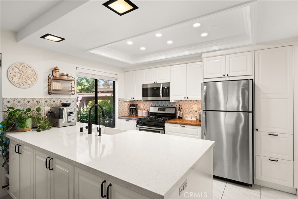 374 South Prospectors Road, Unit 121 Diamond Bar, CA 91765 - Photo 10 of 36 a kitchen with stainless steel appliances a refrigerator sink and microwave