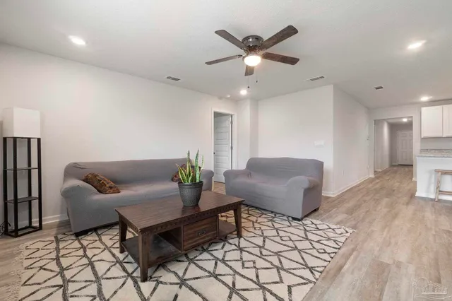 a living room with a couch and a chandelier