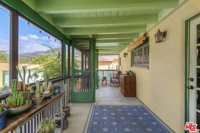 a view of a two chairs and table in the balcony