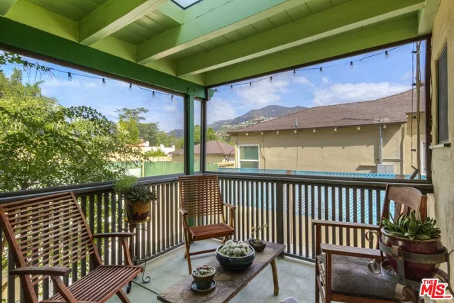 a view of a patio with table and chairs and potted plants