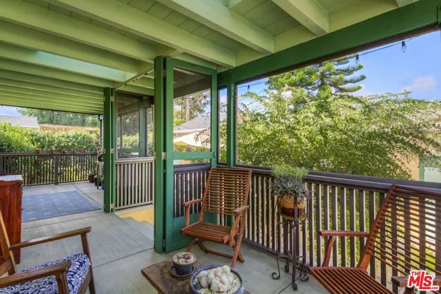 a view of patio with table and chairs under an umbrella