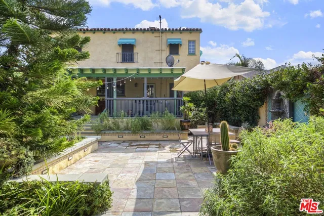a view of a table and chairs under an umbrella