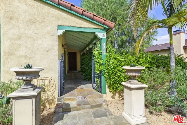 a view of a house with fountain and plants
