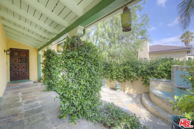a view of backyard with plants and outdoor seating
