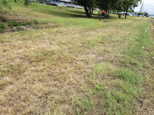 a view of a green field with houses