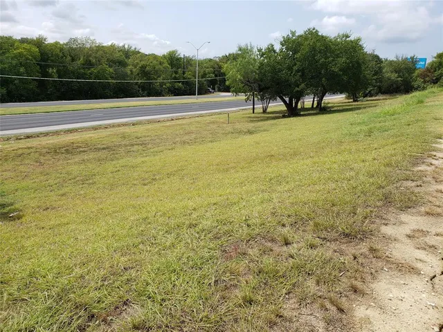a view of a big yard with a large trees