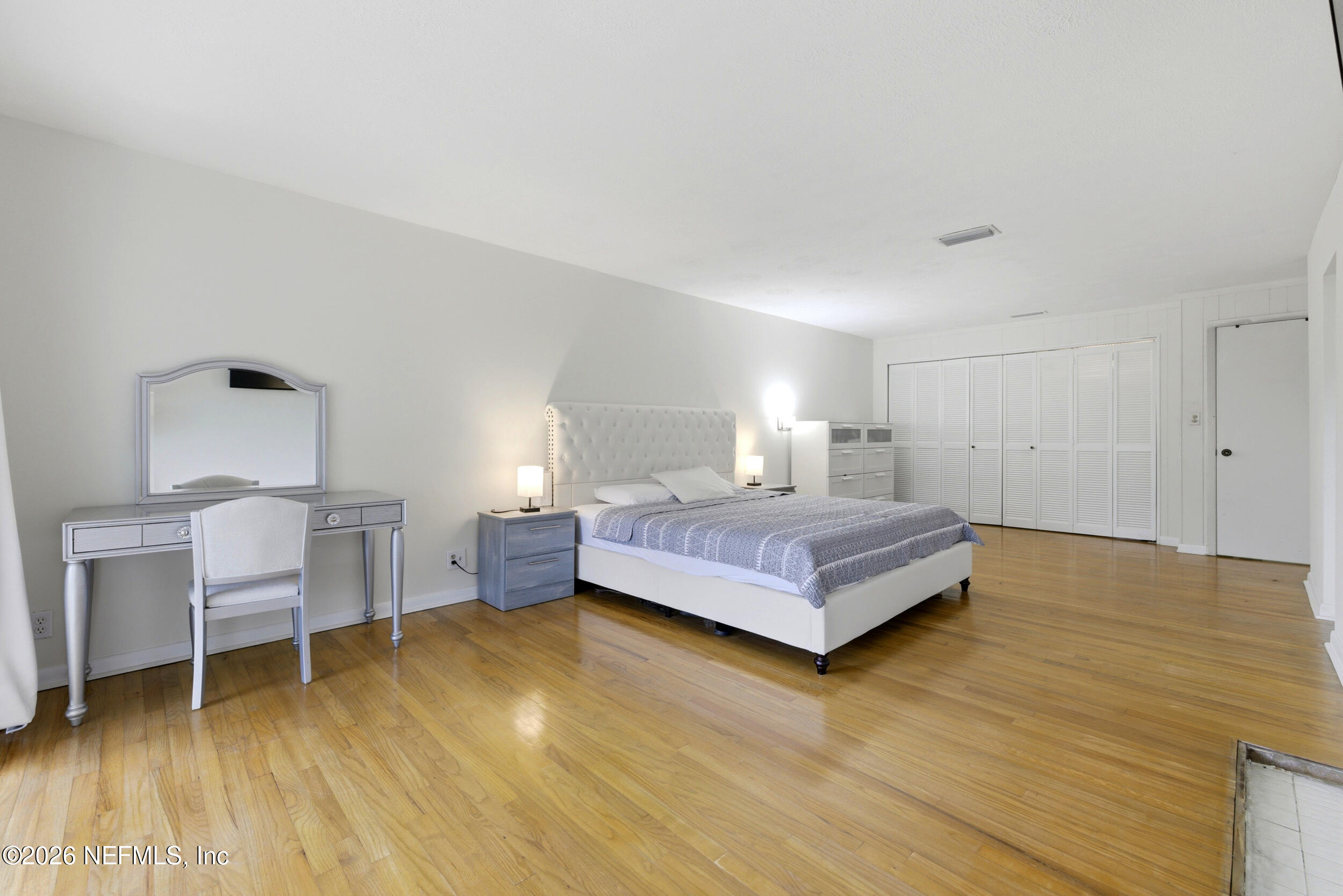 7484 Spinola Road Jacksonville, FL 32217 - Photo 29 of 63 a bedroom with a bed and a table