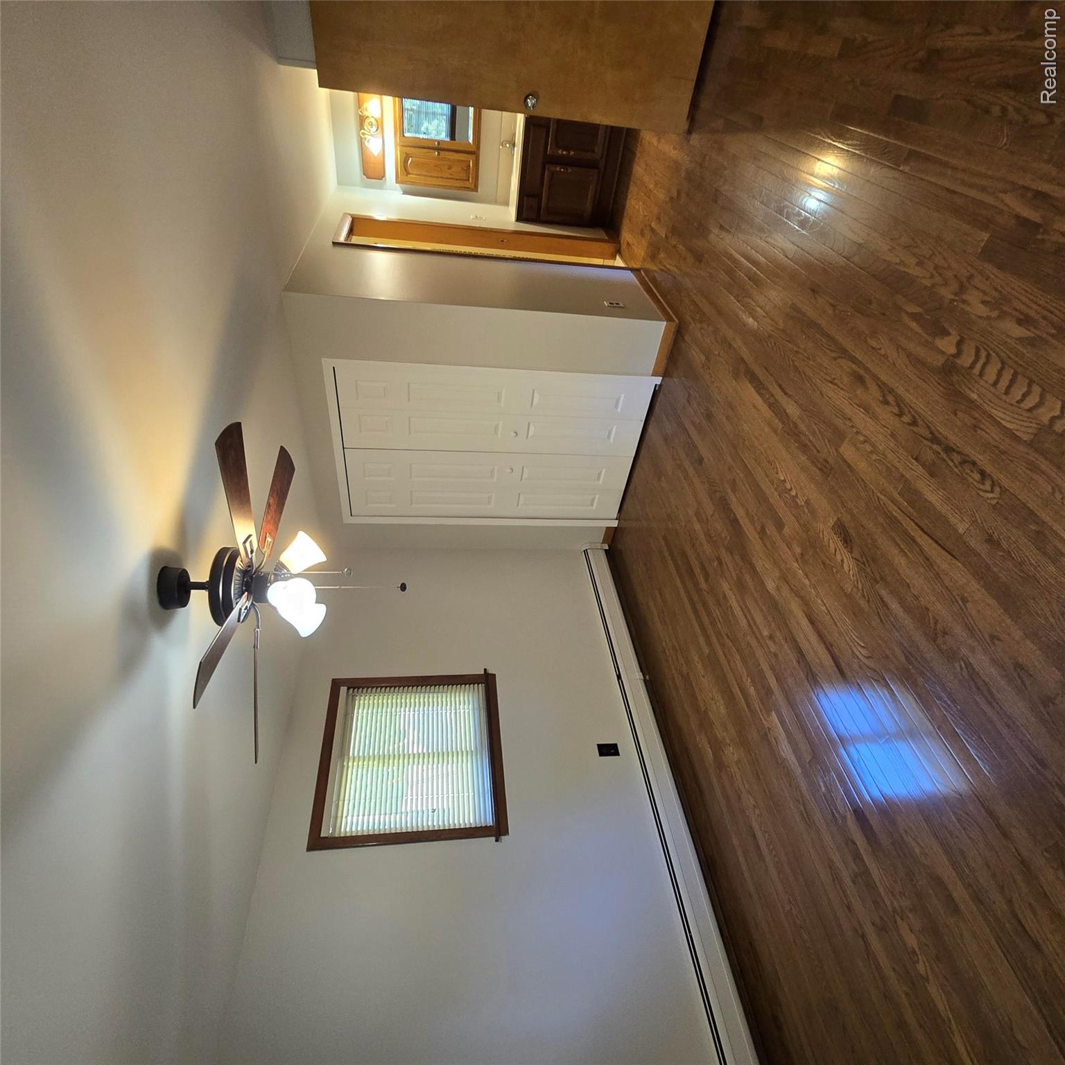 311 Nevada Avenue Rochester, MI 48309 - Photo 29 of 70 Spacious room featuring wood-finish flooring, a window with blinds, and white bi-fold closet doors
