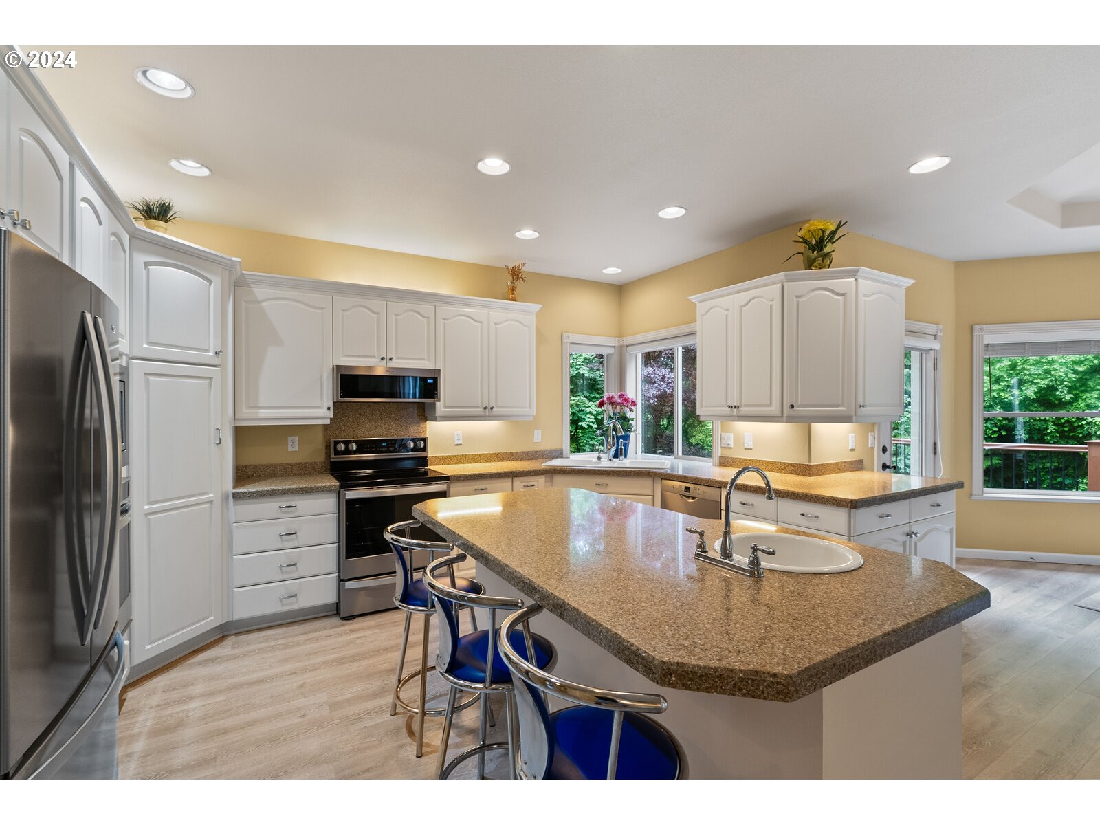 31500 Northwest 13th Avenue Ridgefield, WA 98642 - Photo 20 of 48 a kitchen with stainless steel appliances granite countertop a sink a stove a refrigerator cabinets and a dining table