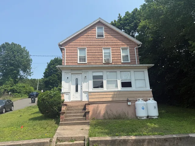 a front view of a house with a yard