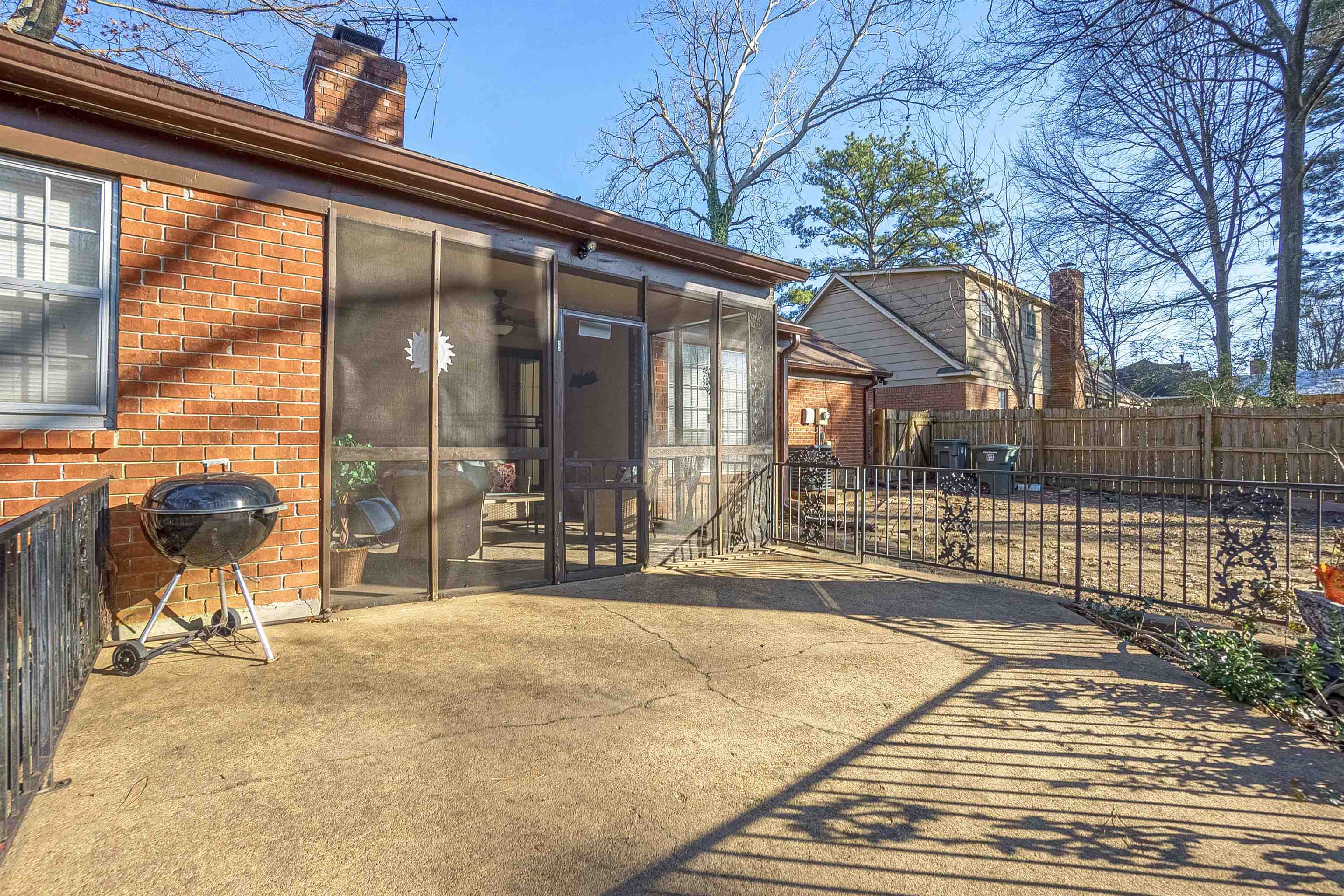 3467 Fox Meadows Road Memphis, TN 38115 - Photo 15 of 15 Rear view of house featuring a patio area and a sunroom