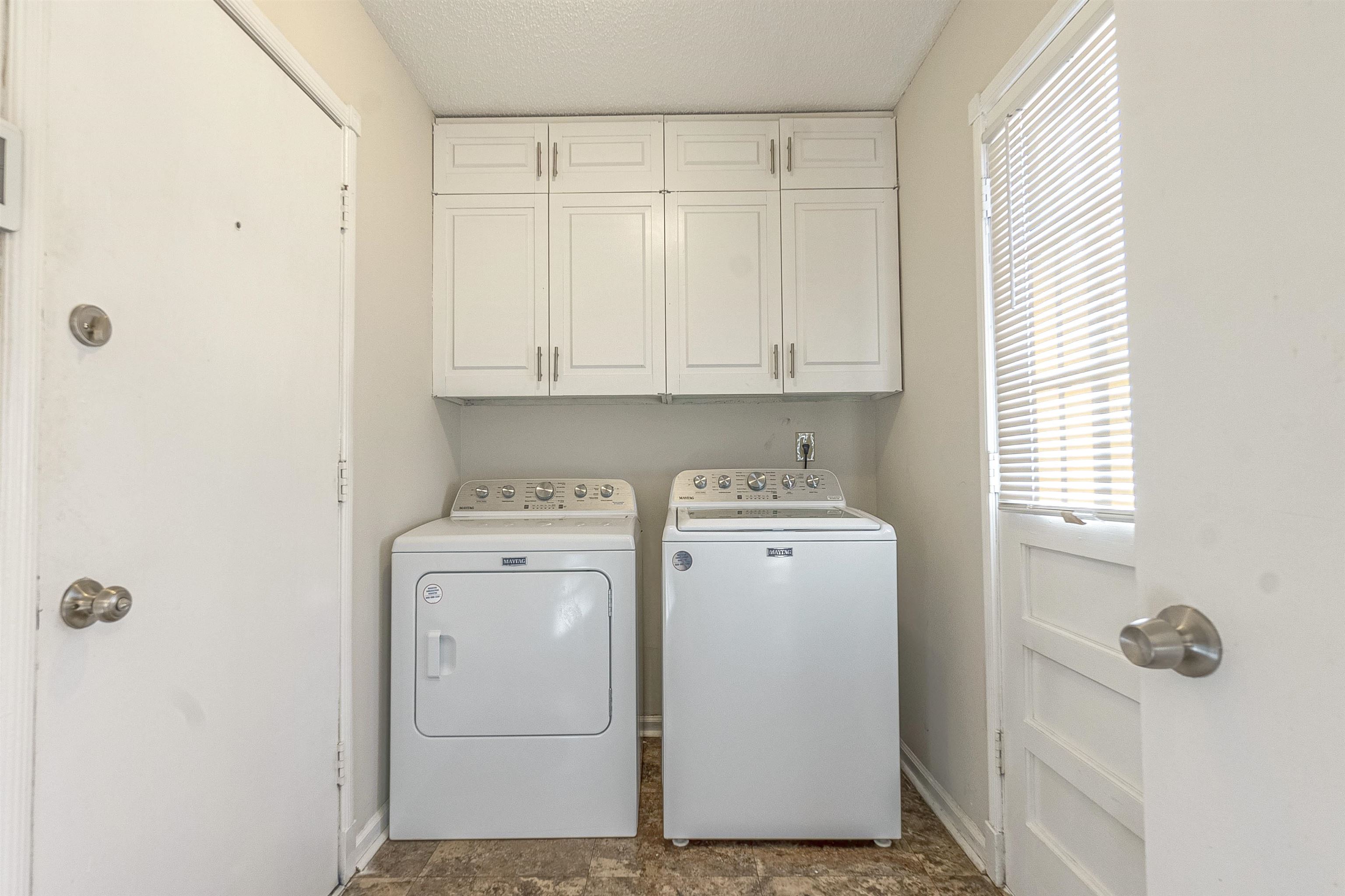 3467 Fox Meadows Road Memphis, TN 38115 - Photo 7 of 15 Laundry room featuring cabinets and separate washer and dryer