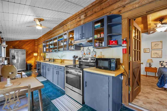 a kitchen with stainless steel appliances granite countertop a stove and cabinets