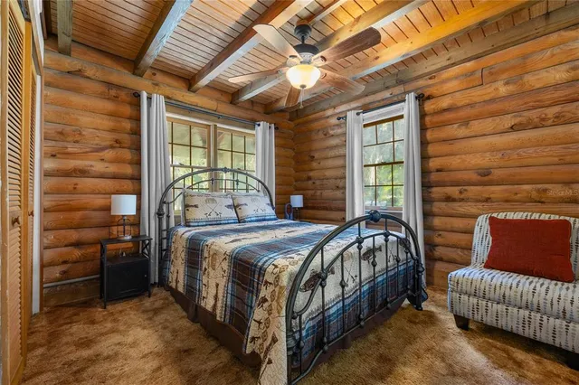 a bedroom with a bed and a chair