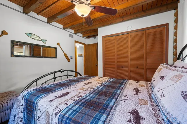 a spacious bedroom with a bed and a couch