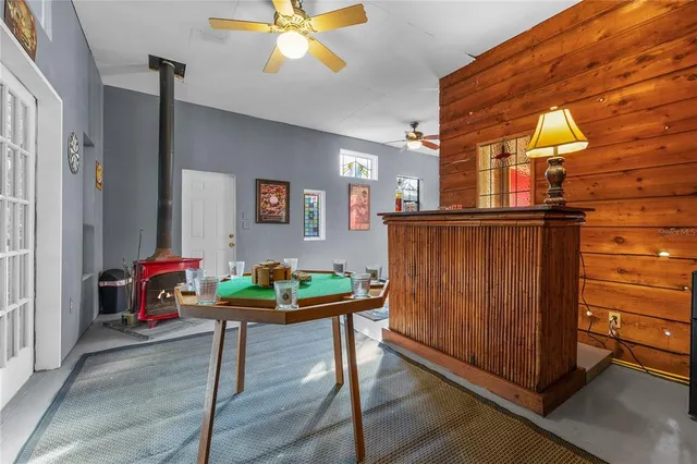 a roof deck with table and chairs under an umbrella