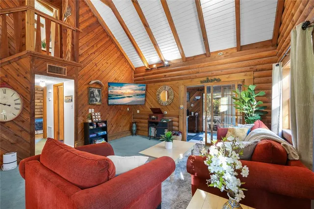 a view of a dining room with furniture a chandelier and wooden floor