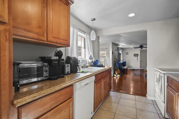 a kitchen with stainless steel appliances granite countertop a refrigerator and a stove top oven