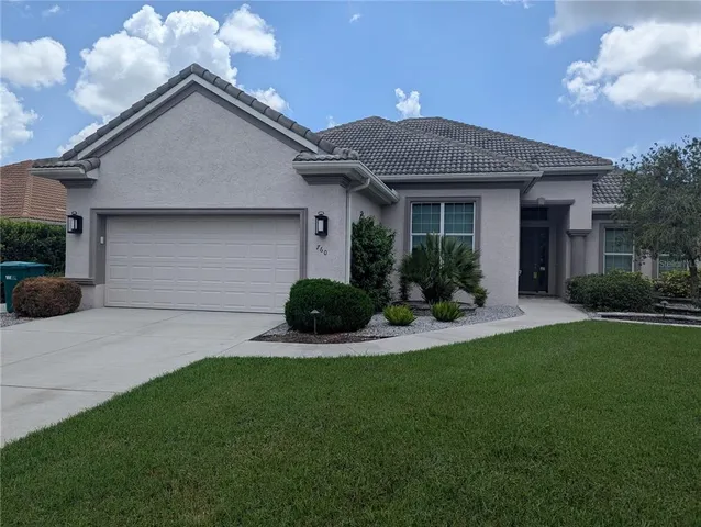 a front view of a house with a yard and porch