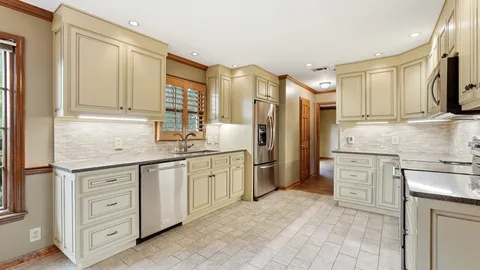 a kitchen with stainless steel appliances granite countertop a stove microwave and cabinets
